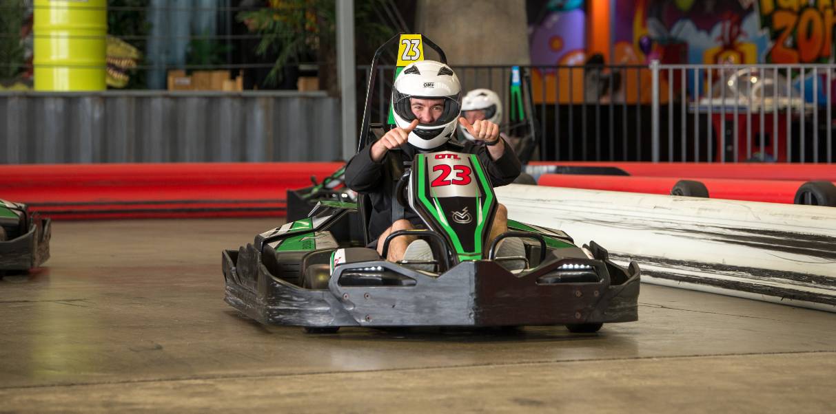 man driving an indoor go-kart